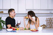 © mikitiger - cute young woman and man in white kitchen near table in house