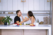 © mikitiger - cute young woman and man in white kitchen near table in house