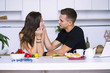 © mikitiger - cute young woman and man in white kitchen near table in house