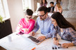 © NDABCREATIVITY - Picture of young architects discussing in office