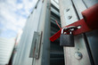 © pressmaster - Close-up of closed cargo container on lock, sealed container in warehouse area