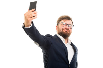 Wall Mural - Portrait of business man doing selfie with smartphone.