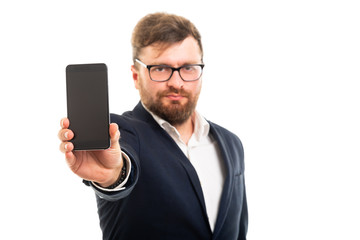 Wall Mural - Portrait of business man showing smartphone to the camera.