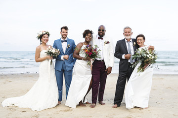 Wall Mural - Three newly wed couples on the beach