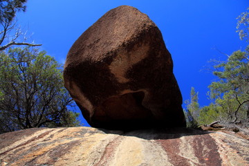 Brown granite boulder on a blue sky