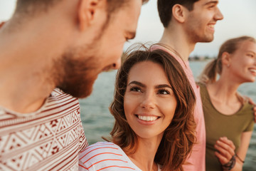 Sticker - Loving couples outdoors on the beach.