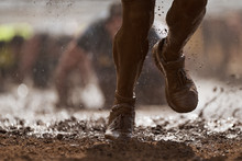 Mud Race Runners.Crawling,passing Under A Barbed Wire Obstacles During Extreme Obstacle Race