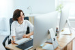 © puhhha - Woman Working On Project On Computer In Office
