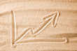 © adragan - Beach and arrow chart up in the sand. concept of sales growth, growth in prices in the turistic summer season