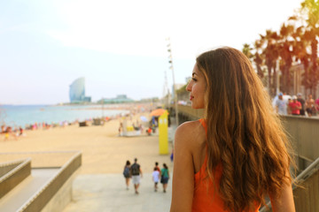 Happy city woman go to the beach at sunset. Lifestyle concept.