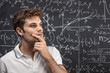 © tiero - man student thinking blackboard mathematics. concept of education study