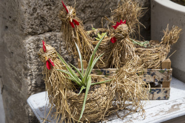 hand made work composition with straw representing three hens