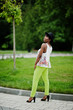 © AS Photo Family - Amazing african american model woman in green pants and black hat posed at park.