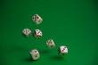 © Denis - dice in the fall on a green background