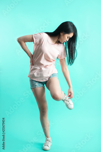 Asian Sporty Woman With Long Hair In Denim Shorts Adjusting Laces On Her Boots Beautiful Asian Girl Oriental Girl Black Hair Long Teenager Young Model Student Pretty Buy This Stock Photo