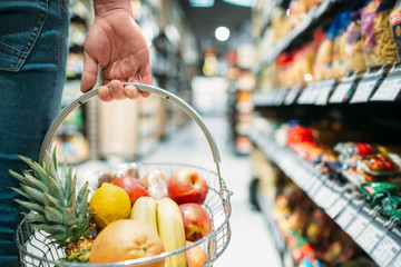 Wall Mural - Male customer hand with basket, supermarket