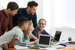 © Africa Studio - Group of teenagers doing homework with teacher in classroom