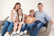 © New Africa - Happy family with cute children on sofa at home