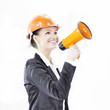 © yurolaitsalbert - confident female engineer with a megaphone on the background of the office.