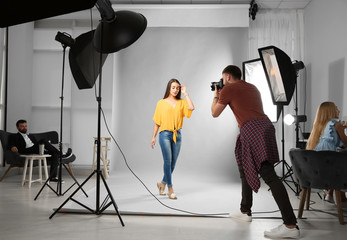 Professional team working with model in photo studio