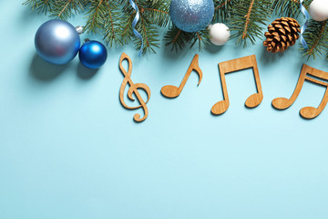 Flat lay composition with decorations and notes on color background. Christmas music concept