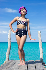 Wall Mural - woman in retro swimsuit on the mole over sea