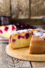 Wall Mural - Cherry cake and slice of cake on rustic table