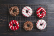 © Cavan Images - Overhead view of colorful donuts on cooling rack
