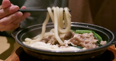 Wall Mural - Woman eating udon in Japanese restaurant