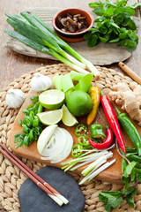 Wall Mural - Vietnamese food ingredient board - ginger, chili, lime, spring onion, garlic, shallots, shiitake mushroom, mint, cilantro, coriander. All colorful spices make traditional Asian food more delicious.