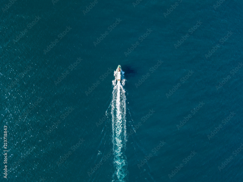 top view of fast travel boat going straight forward in the sea aerial ...