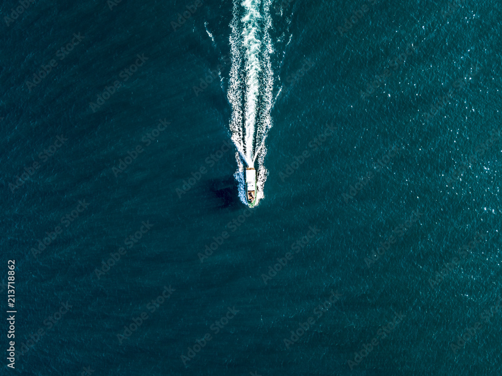 top view of fast travel boat going straight forward in the sea aerial ...