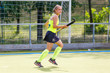 © skumer - Young field hockey player girl with stick in the game