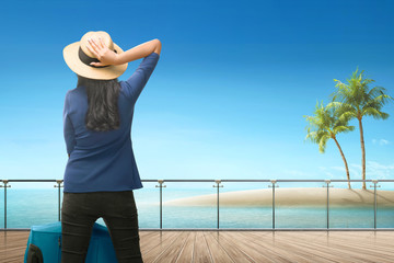 Back view of asian female traveler looking at ocean view