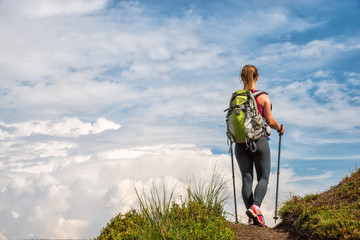 Wall Mural - young woman hiking in the mountains
