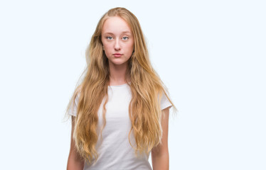 Wall Mural - Blonde teenager woman with a confident expression on smart face thinking serious