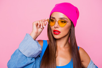 What`s on her mind?! Close up portrait of young brunette model looking away, wearing casual outfit isolated on pink vivid background