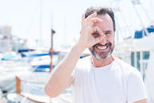 Handsome Middle Age Man In Marina With Happy Face Smiling Doing Ok Sign With Hand On Eye Looking Through Fingers