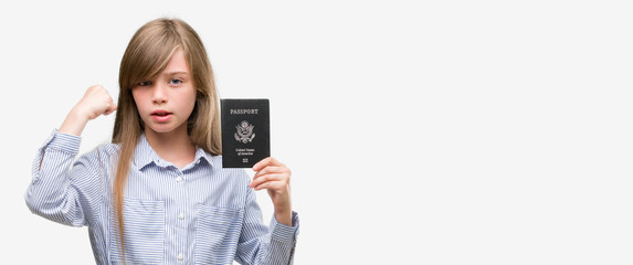 Sticker - Young blonde toddler holding american passport annoyed and frustrated shouting with anger, crazy and yelling with raised hand, anger concept