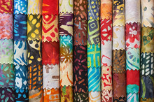 Stack Of Colorful Quilting Batik Fabrics As A Vibrant Background Image