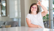 © Krakenimages.com - Down syndrome woman at home doing ok sign with fingers, excellent symbol