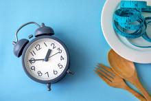 Time To Lose Weight , Eating Control Or Time To Diet Concept , Alarm Clock With A Healthy Tool Concept Decoration On Blue Background