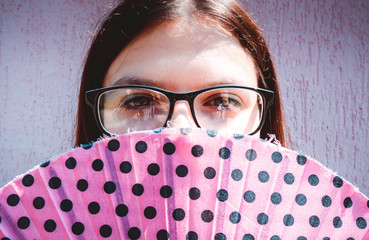 Poster -  girl or young woman widh glasses holds hand fan