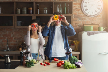 Wall Mural - Happy couple cooking healthy food together