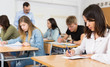 © JackF - Young girl is writing test and thinking about questions at the desk