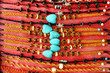 Top view on a handmade colorful bracelets decorated wooden beads, blue stones and metal fittings.