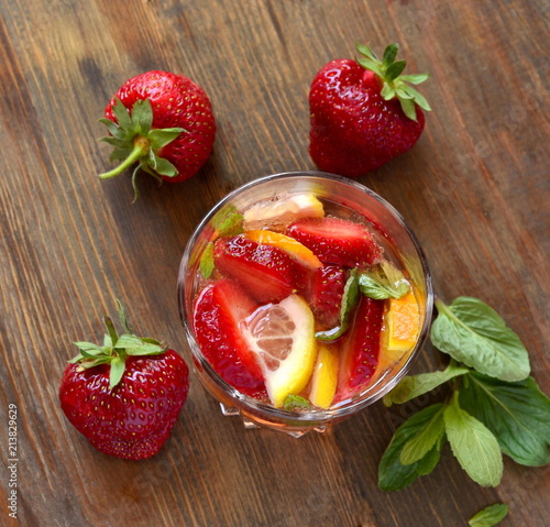 Fotografía Refreshing summer drink with strawberries and citrus, top view