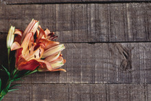 Beautiful Orange Lily Flower On Rustic Wooden Background Flat Lay. Gorgeous Bloom Minimalistic  On Rustic Wood Backdrop. Space For Text. Greeting Card. Celebration Concept. Spring Image