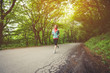 © yanik88 - Young fitness blonde woman in headphones running at morning caucasian forest trail in sun light