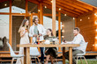 © rh2010 - Young friends having fun during the dinner on the backyard of the modern wooden country house outdoors